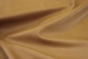Close up picture of warm gold full grain upholstery leather