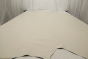 Picture of a pearl colored smooth grain leather for upholstery displayed on a table 