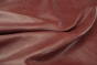 Close up picture of vibrant multitone bordeaux distress leather for upholstery