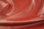 Close up of bright barn red full grain upholstery leather