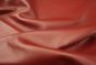 Close up of bright barn red full grain upholstery leather