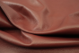 Close up picture of deep warm red full grain leather for upholstery