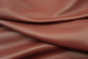 Close up picture of deep warm red full grain leather for upholstery