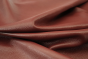 Close up picture of deep warm red full grain leather for upholstery