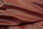 Close up picture of rich dark red Italian leather for upholstery
