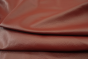 Close up picture of rich dark red Italian leather for upholstery