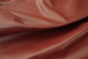 Close up picture of rich dark red Italian leather for upholstery