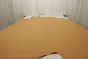 Picture of soft golden camel full grain leather for upholstery displayed on a table
