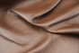 Close up of rich dark brown with red/brown undertones Italian upholstery leather