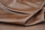 Close up of rich dark brown with red/brown undertones Italian upholstery leather