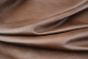 Close up of rich dark brown with red/brown undertones Italian upholstery leather