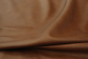 Close up of warm brown with reddish hue semi aniline upholstery leather