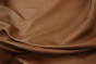 Close up of warm brown with reddish hue semi aniline upholstery leather