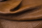 Close up of rich whiskey brown embossed upholstery lambskin leather