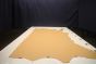 Golden tan colored leather material laying flat on a table 