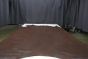 Chocolate colored Italian leather cowhide laying flat on a table 
