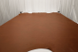 Picture of Baker’s Rum, cognac semi-aniline leather hide for upholstery displayed on a table