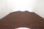 Dark red colored distress leather cowhide laying flat on a table 