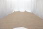Tan colored distress leather cowhide laying flat on a table 
