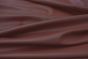 Close up picture of burgundy smooth grain leather for upholstery