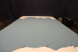 Picture of Blue Whisper, real blue leather hide for upholstery displayed on a table.