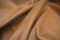 Close up picture of light brown distressed aniline leather for upholstery