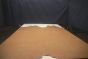 Light brown colored vintage leather cowhide laying flat on a table 