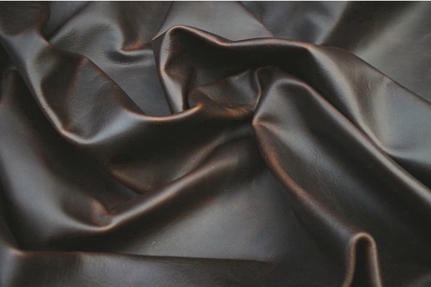 Close up of espresso brown distressed, full grain upholstery leather