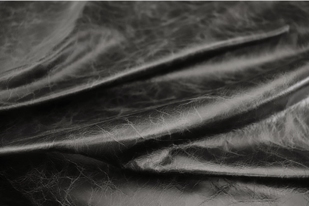 Close up of rich black distress natural grain upholstery leather