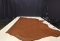 Bourbon colored Italian leather cowhide laying flat on a table 