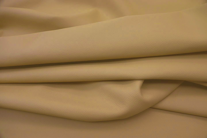 Close up of a warm tan pigmented upholstery leather