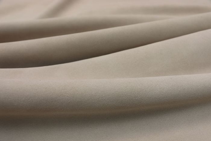 Closeup picture of soft cream suede showing texture of leather