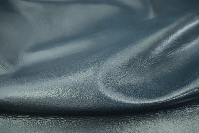 Close up picture of deep blue glazed full grain leather for upholstery