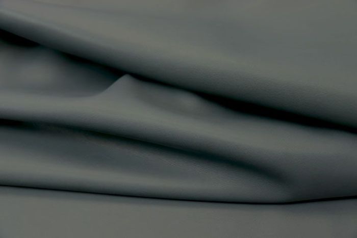 Close-up picture of Midnight Moss, deep forest green colored Italian leather for upholstery.