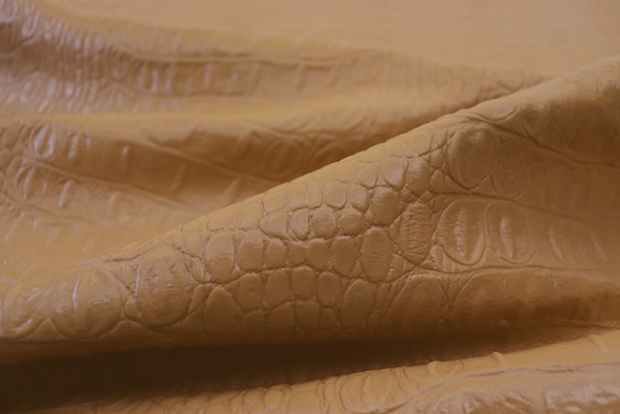Picture of Sand Croc, warm golden embossed leather with croc print showing scales and grain.  