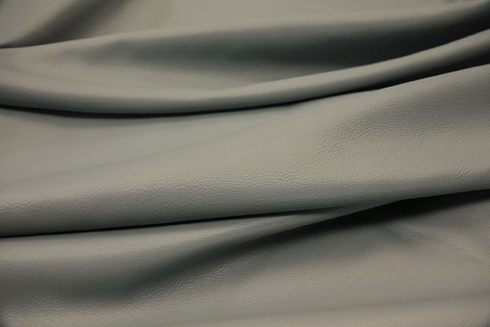 Close-up picture of Blue Whisper soft blue leather for upholstery with natural grain texture.