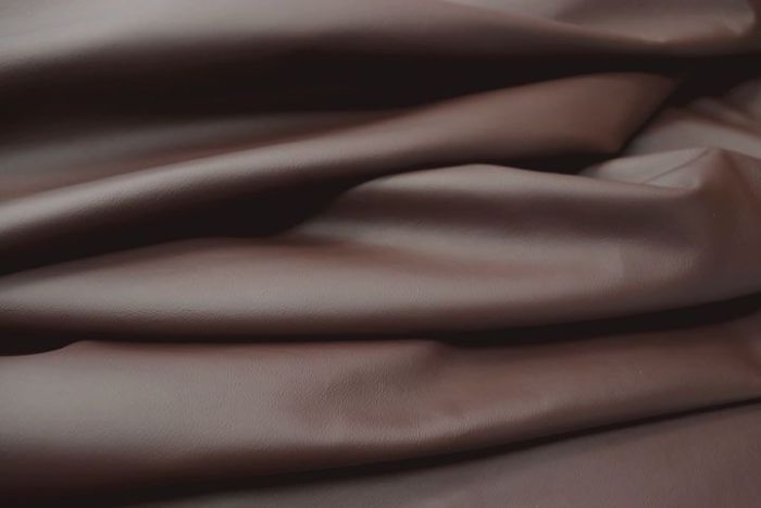 Close up picture of chocolate brown smooth grain leather for upholstery