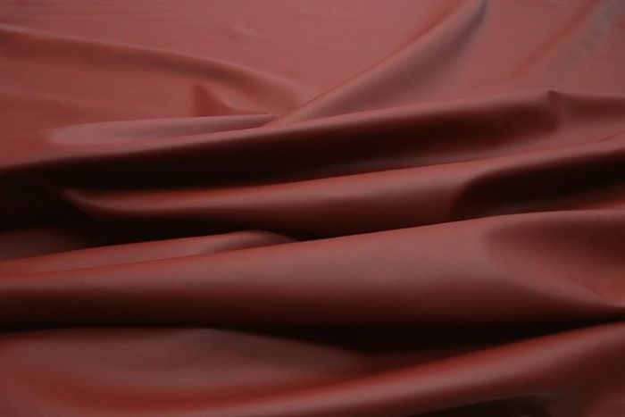 Close up picture of ruby red smooth grain leather for upholstery