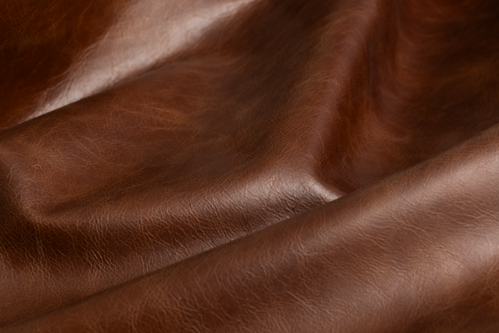 Close up of saddle brown distress upholstery leather