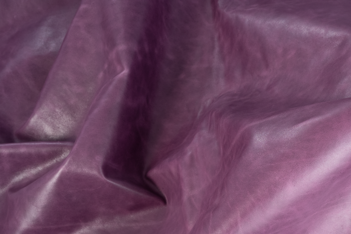 Close up of dark purple with light undertones distress leather for upholstery