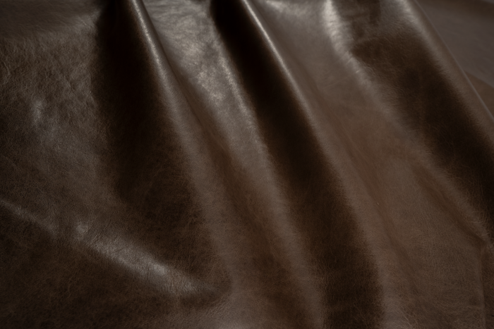 Close up of dark brown with light undertones pull up upholstery leather