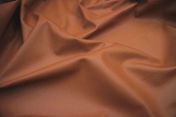Close up picture of orange leather for upholstery