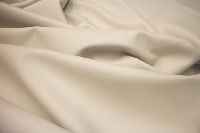 Close up picture of ivory smooth grain leather for upholstery