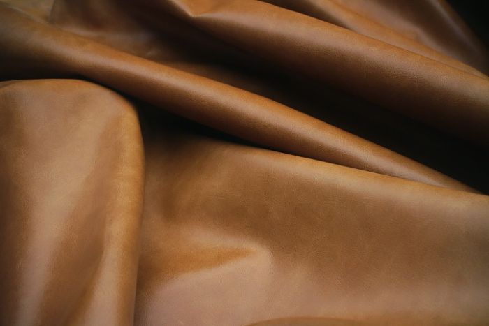 Close up picture of golden brown distressed aniline leather for upholstery
