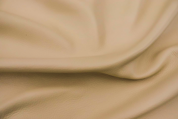 Close up of buttercream color premium top grain leather for upholstery