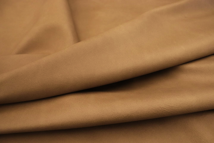 Close up of a light mocha color pull up upholstery leather 