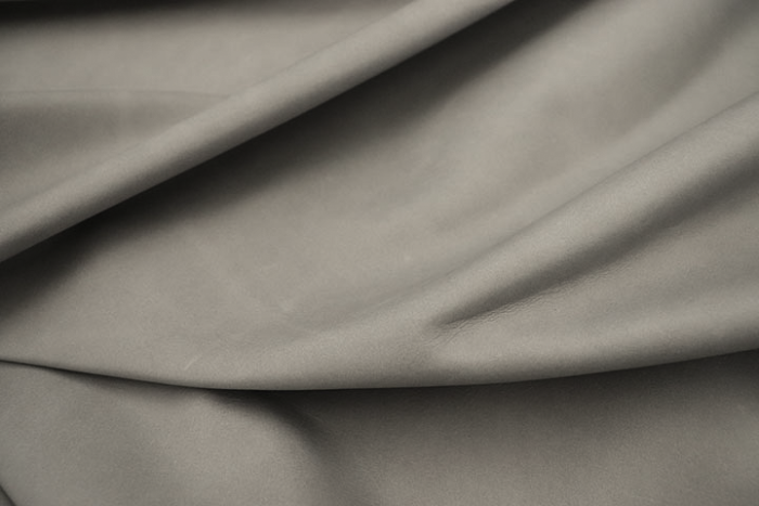 Close up of multitone light grey semi aniline upholstery leather