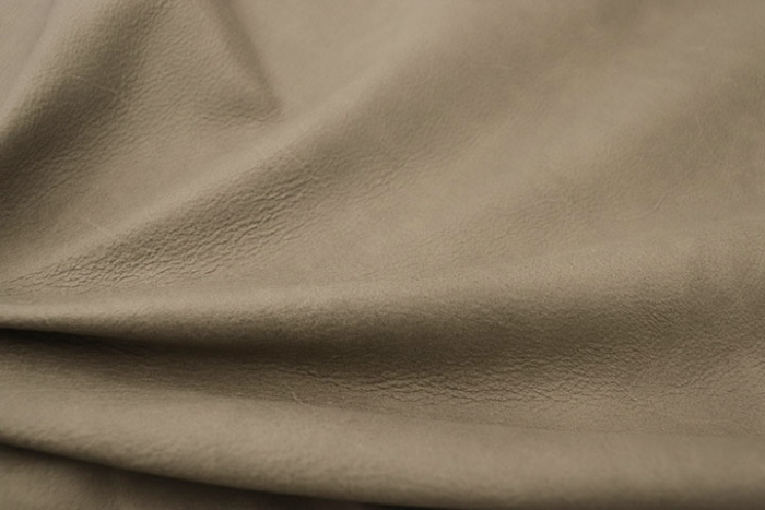 Close up of multitone distressed taupe nappa like leather for upholstery