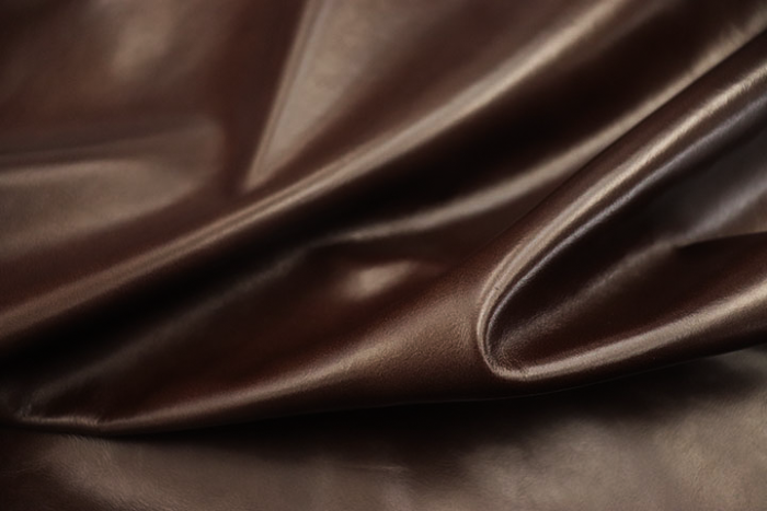Close up of chocolate brown full grain leather for upholstery