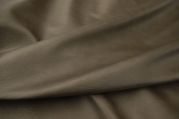 Close up picture of warm multitone grey top grain leather for upholstery